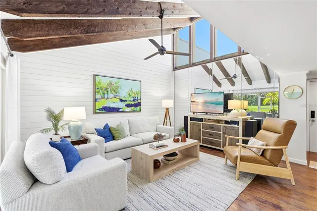 a living room with furniture and view of kitchen