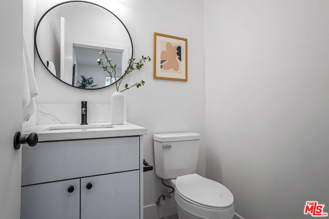 5830 David Avenue Los Angeles, CA 90034 - Photo 25 of 46 a bathroom with a toilet a sink and mirror