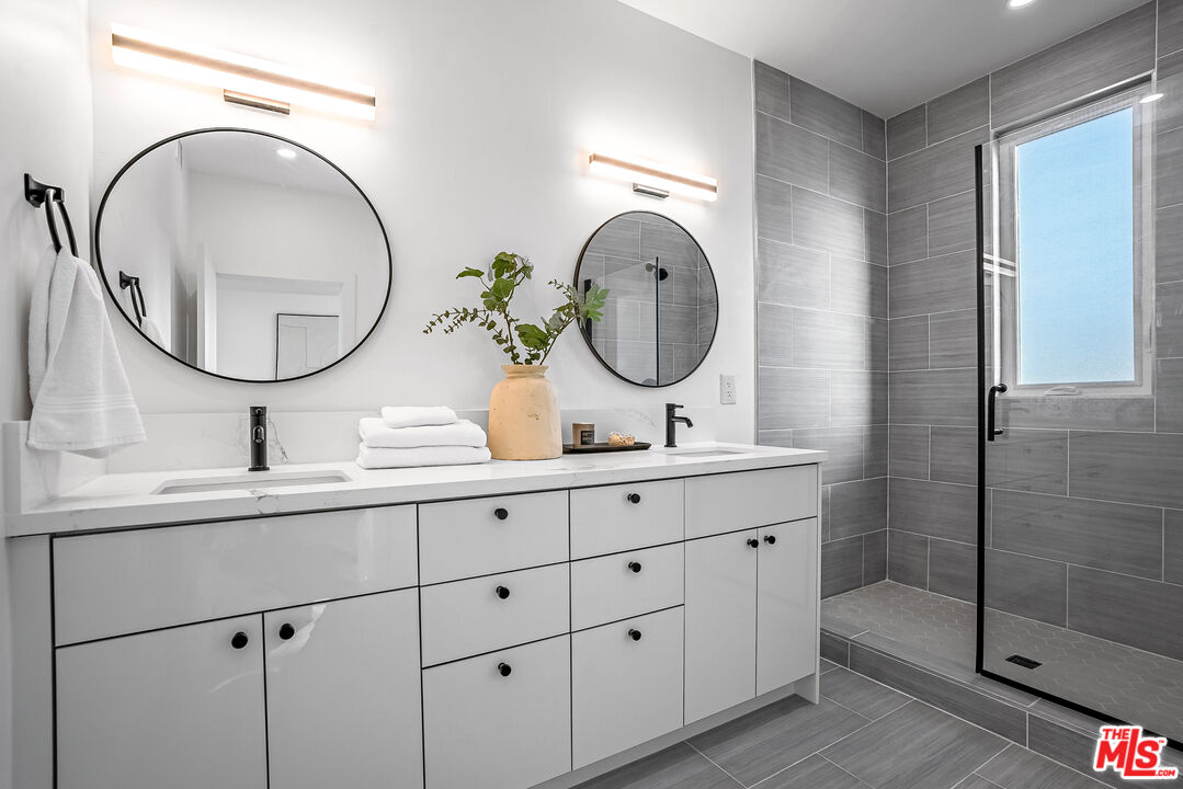 5830 David Avenue Los Angeles, CA 90034 - Photo 33 of 46 a bathroom with a sink and a mirror