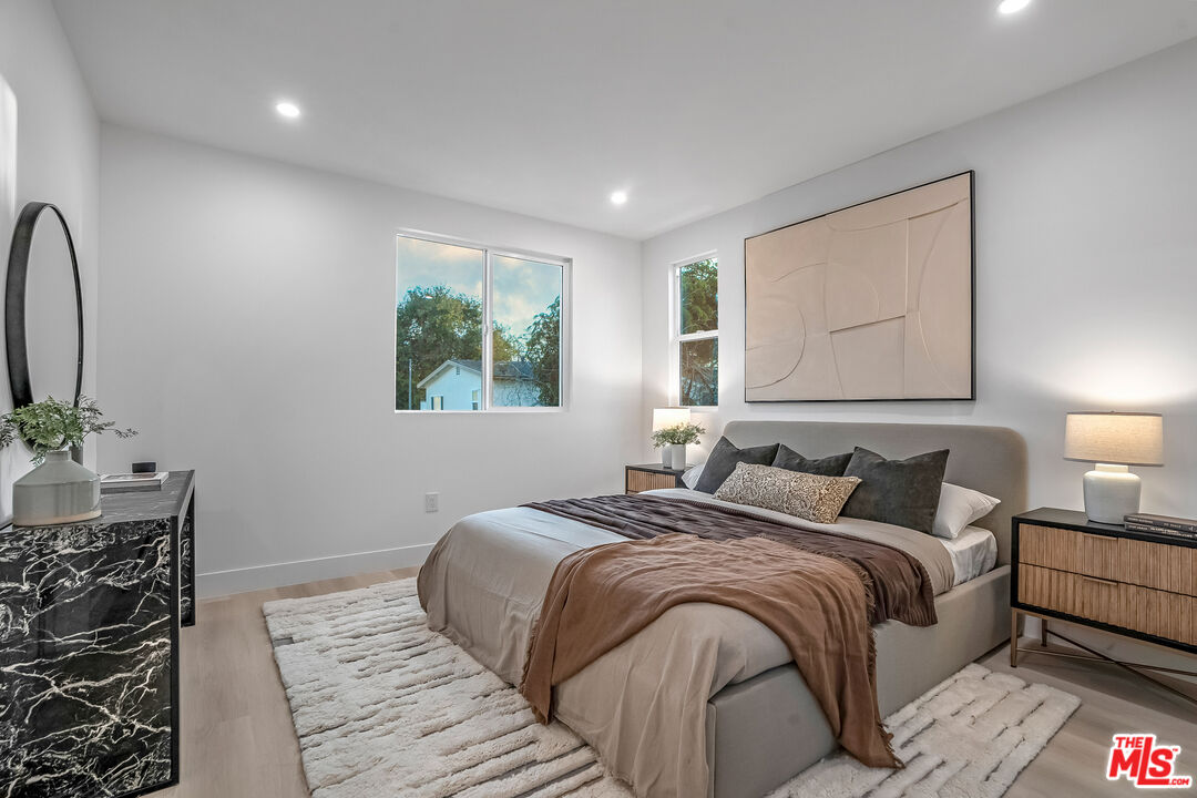 5830 David Avenue Los Angeles, CA 90034 - Photo 40 of 46 a bedroom with a large bed and a potted plant