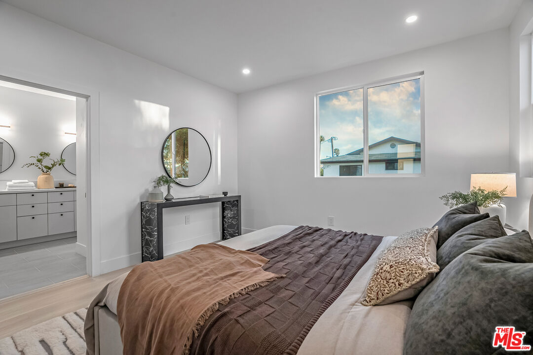 5830 David Avenue Los Angeles, CA 90034 - Photo 41 of 46 a bedroom with a bed a mirror and a dresser