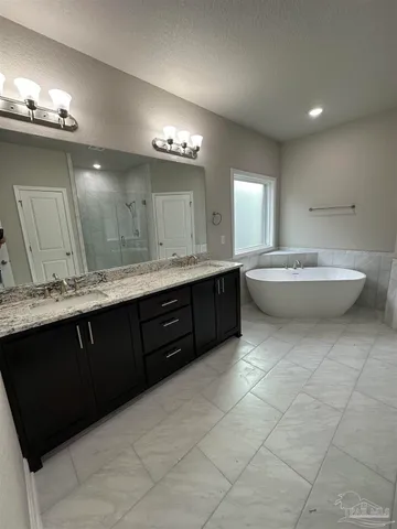 a spacious bathroom with a double vanity sink mirror and toilet