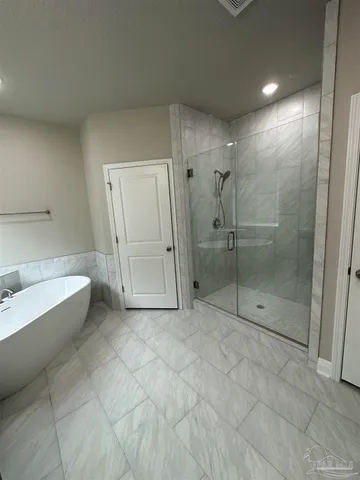 a bathroom with a shower and a bathtub