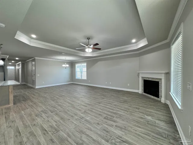 wooden floor in an empty room with a fireplace