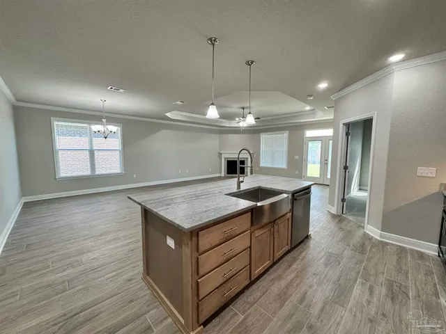 a kitchen with a stove and a wooden floor