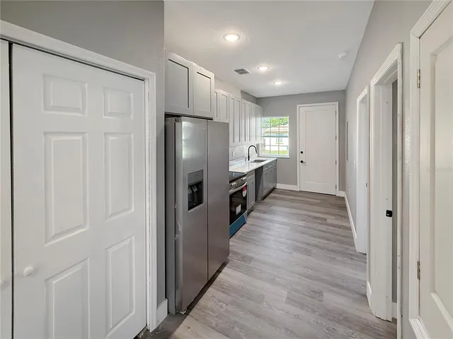 a view of a refrigerator in kitchen and wooden floor