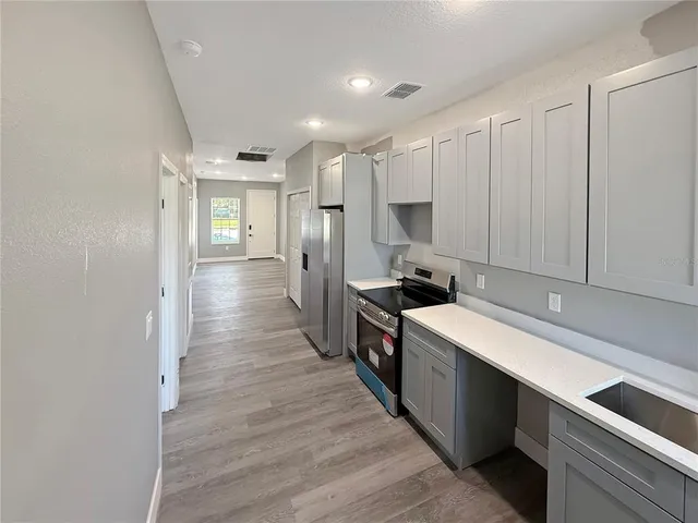a kitchen with a sink and refrigerator