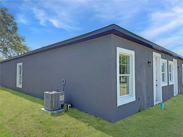 a backyard of a house with table and chairs