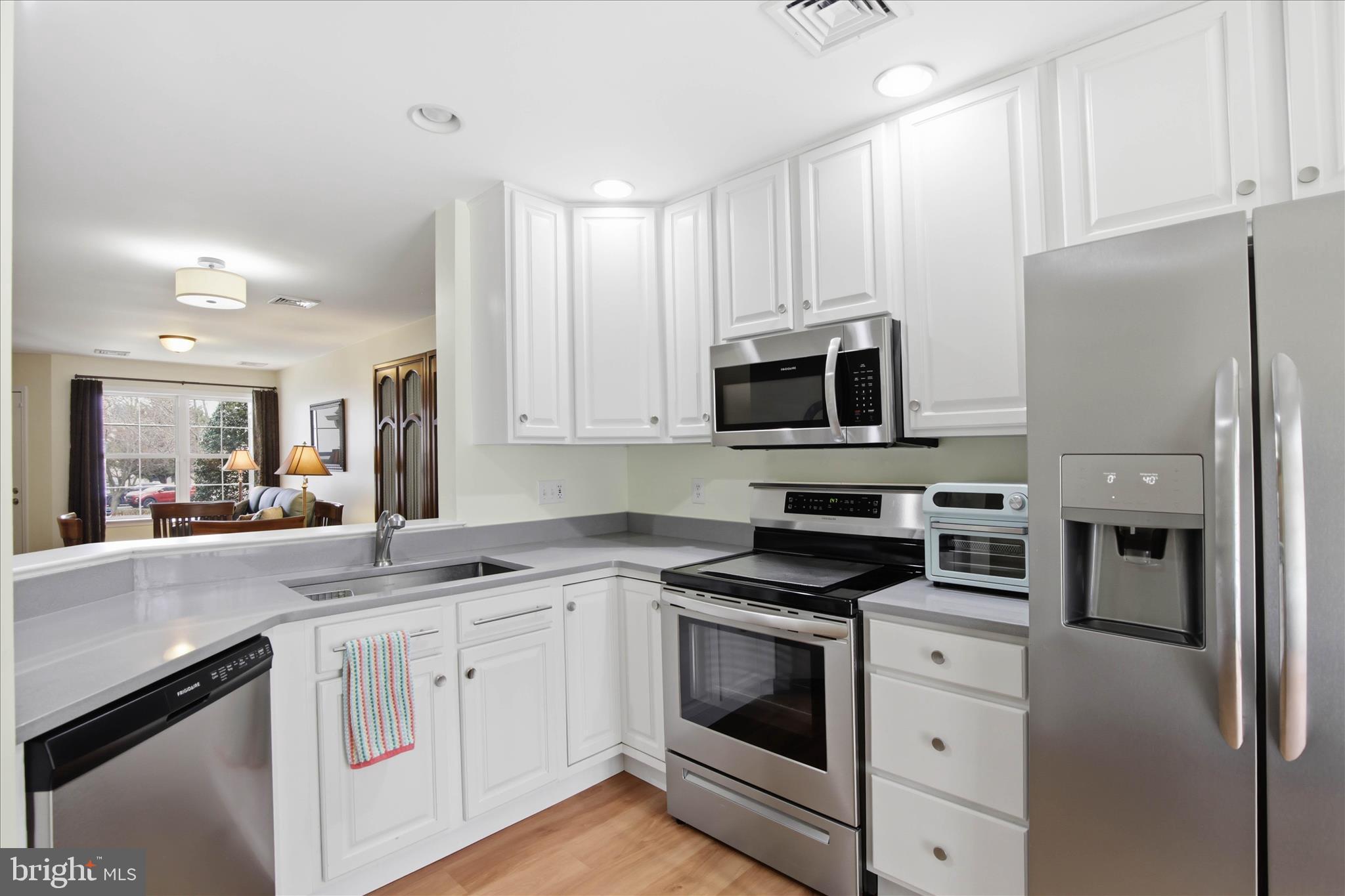 52 Coopers Way Denver, PA 17517 - Photo 11 of 29 a kitchen with granite countertop a refrigerator stove and microwave