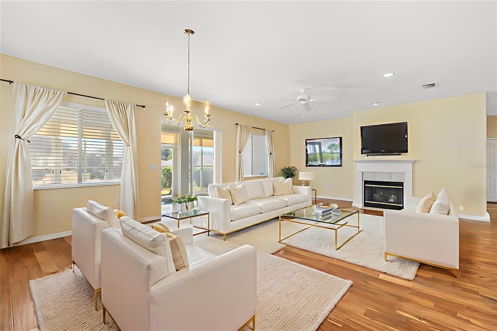 13655 Southeast 97th Terrace Road Summerfield, FL 34491 - Photo 11 of 49 a living room with furniture a fireplace and a flat screen tv