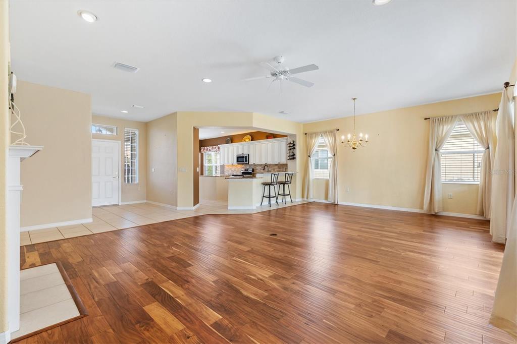 13655 Southeast 97th Terrace Road Summerfield, FL 34491 - Photo 14 of 49 a view of a kitchen with a fridge and wooden floor
