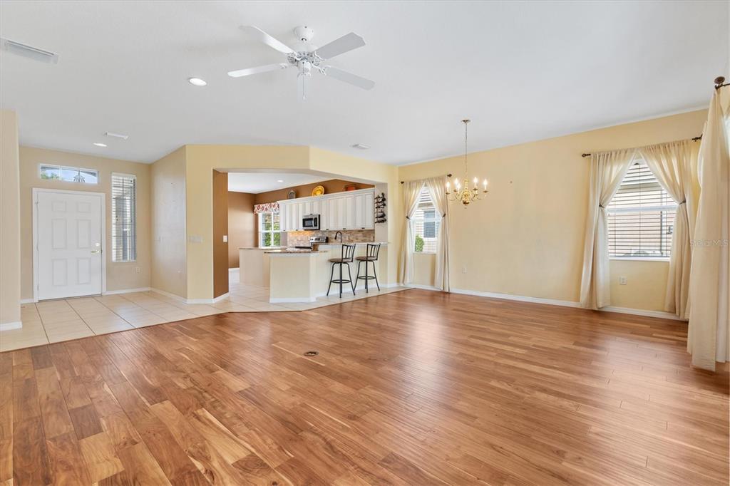 13655 Southeast 97th Terrace Road Summerfield, FL 34491 - Photo 15 of 49 a view of a kitchen with wooden floor and a ceiling fan