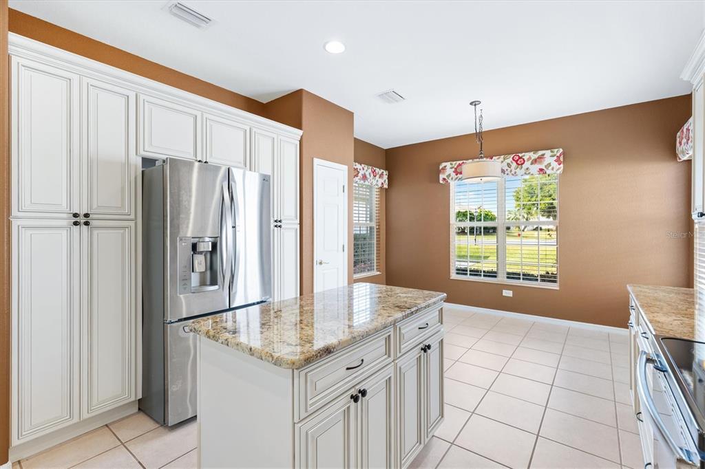 13655 Southeast 97th Terrace Road Summerfield, FL 34491 - Photo 16 of 49 a kitchen with stainless steel appliances granite countertop a refrigerator and a sink