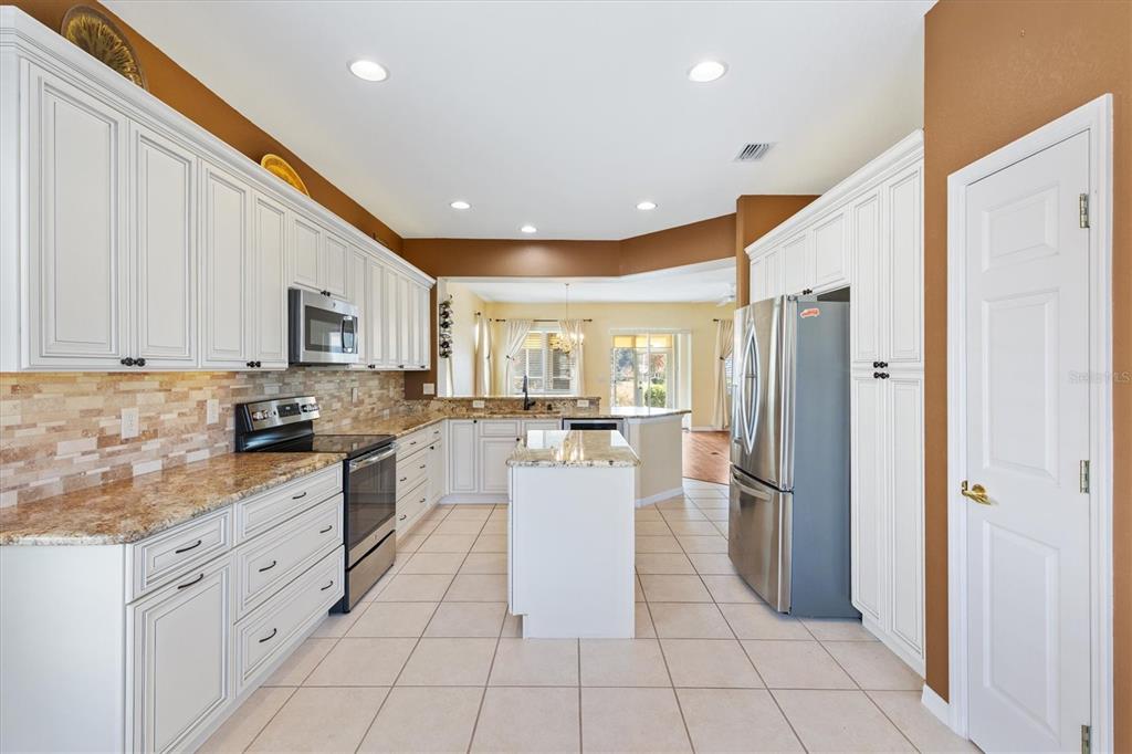 13655 Southeast 97th Terrace Road Summerfield, FL 34491 - Photo 19 of 49 a kitchen with a refrigerator and a sink