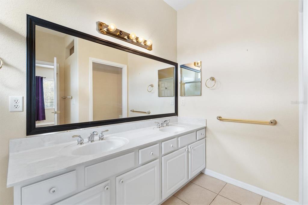13655 Southeast 97th Terrace Road Summerfield, FL 34491 - Photo 24 of 49 a bathroom with a double vanity sink and mirror
