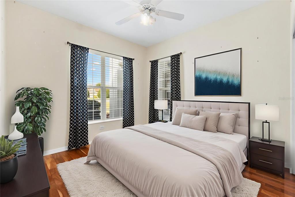 13655 Southeast 97th Terrace Road Summerfield, FL 34491 - Photo 30 of 49 a bedroom with a large bed and a chandelier