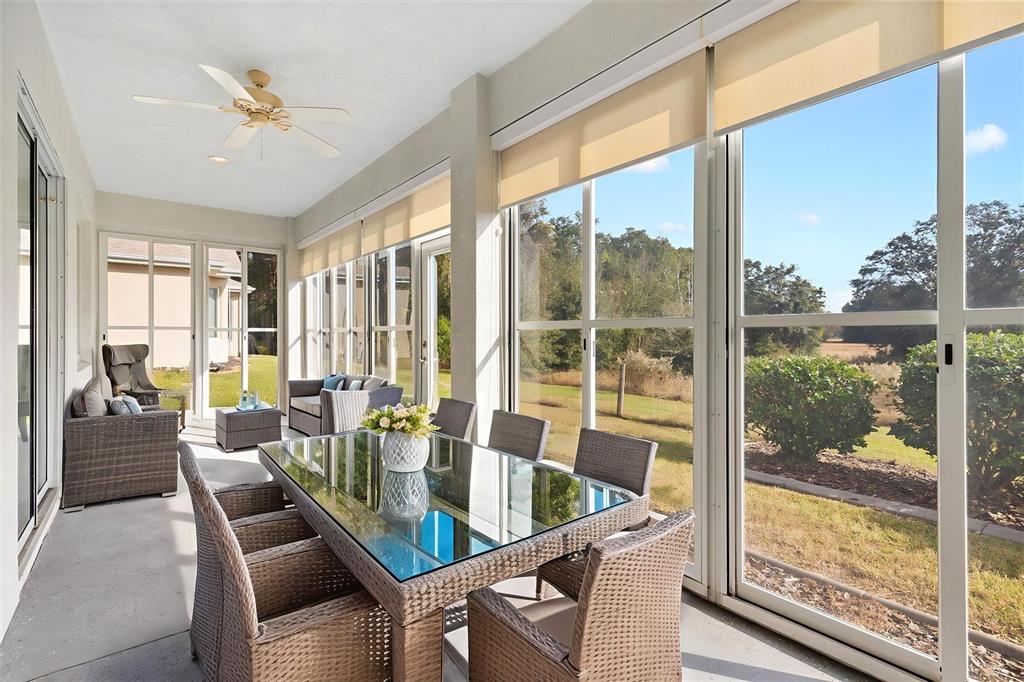 13655 Southeast 97th Terrace Road Summerfield, FL 34491 - Photo 34 of 49 a dining room with furniture water view and a floor to ceiling window