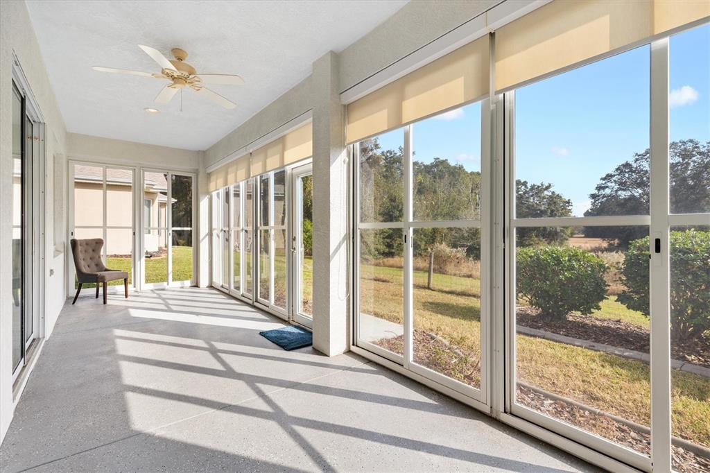 13655 Southeast 97th Terrace Road Summerfield, FL 34491 - Photo 35 of 49 a spacious bedroom with a large window and a balcony