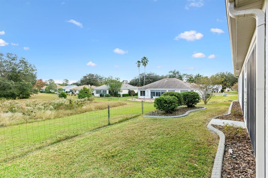 13655 Southeast 97th Terrace Road Summerfield, FL 34491 - Photo 42 of 49 a view of a garden with a building