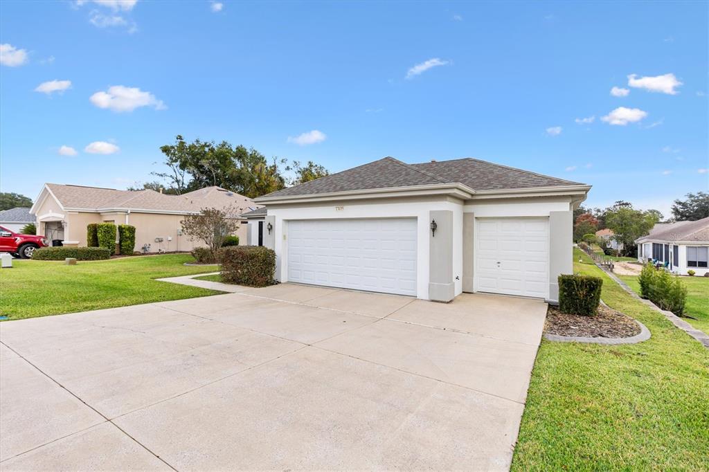 13655 Southeast 97th Terrace Road Summerfield, FL 34491 - Photo 5 of 49 a view of a house with a big yard and potted plants