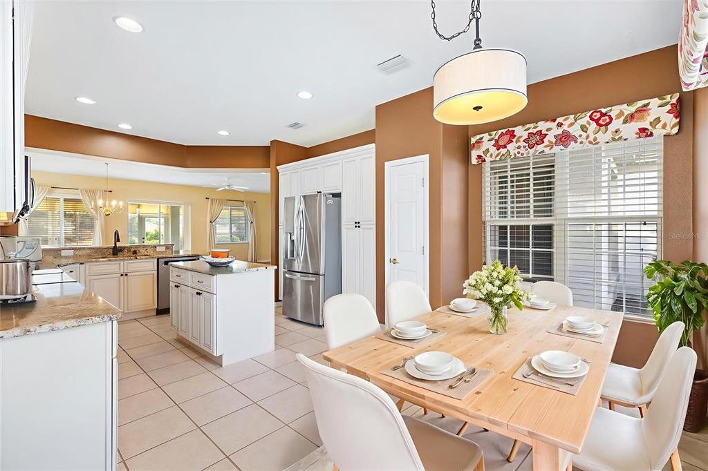 13655 Southeast 97th Terrace Road Summerfield, FL 34491 - Photo 7 of 49 a outdoor dining room with furniture a kitchen island furniture and a chandelier