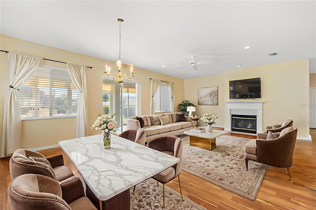 13655 Southeast 97th Terrace Road Summerfield, FL 34491 - Photo 9 of 49 a living room with furniture a flat screen tv and a fireplace