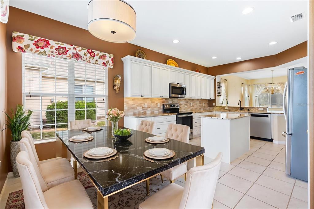 13655 Southeast 97th Terrace Road Summerfield, FL 34491 - Photo 10 of 49 a open kitchen with stainless steel appliances kitchen island granite countertop a sink and cabinets