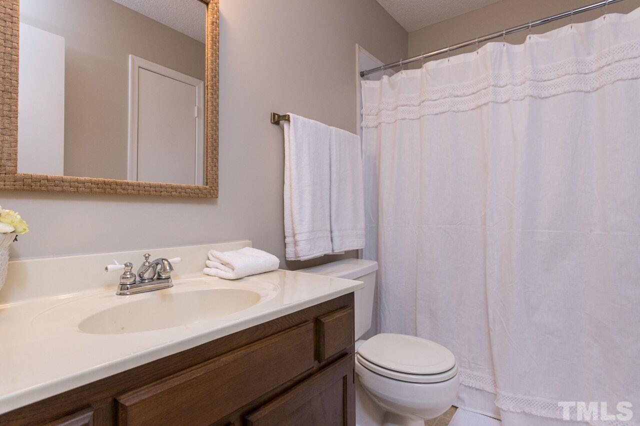 718 Red Forest Trail Raleigh, NC 27615 - Photo 22 of 30 Hall Bathroom located between the secondary rooms. Newly painted, new light and decorative mirror.