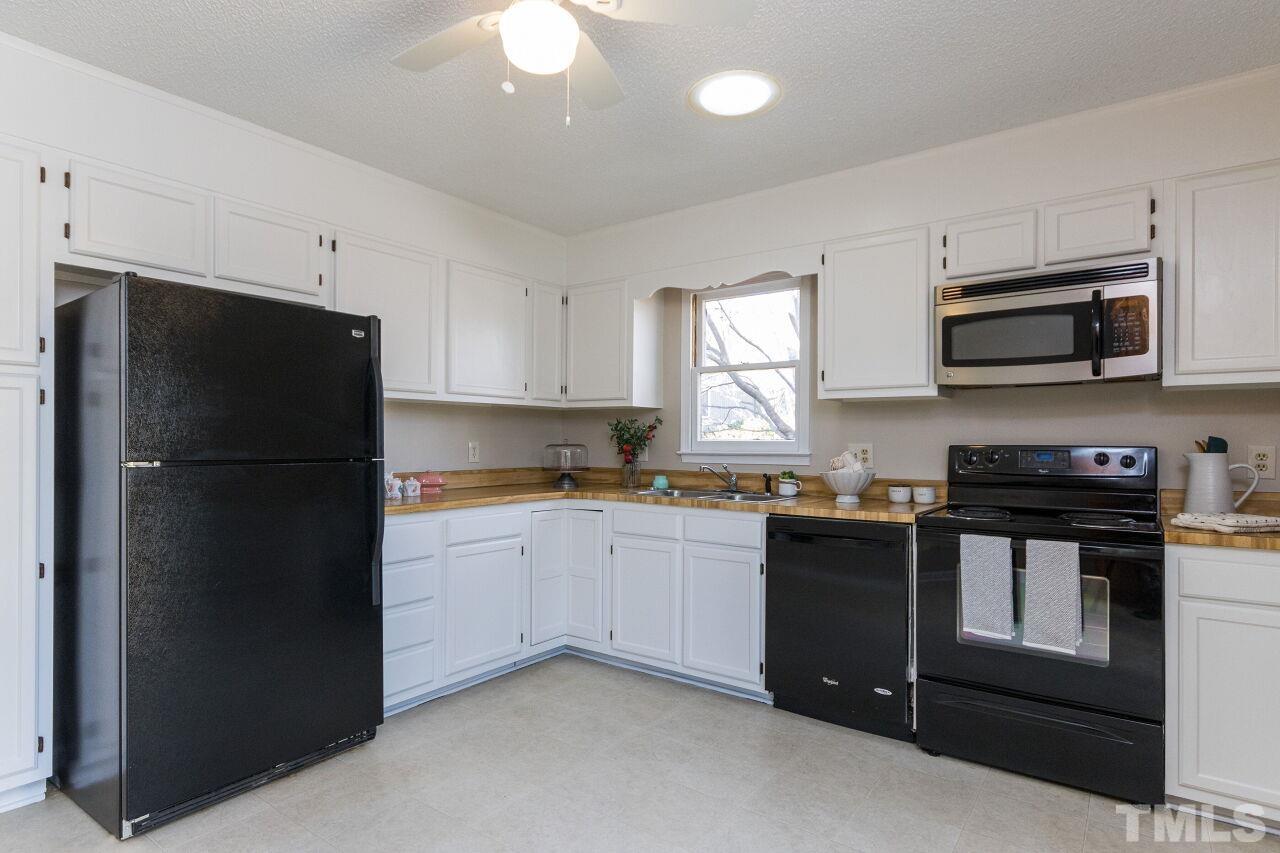 718 Red Forest Trail Raleigh, NC 27615 - Photo 10 of 30 Kitchen is located in the back of the home overlooking the private yard with large patio.