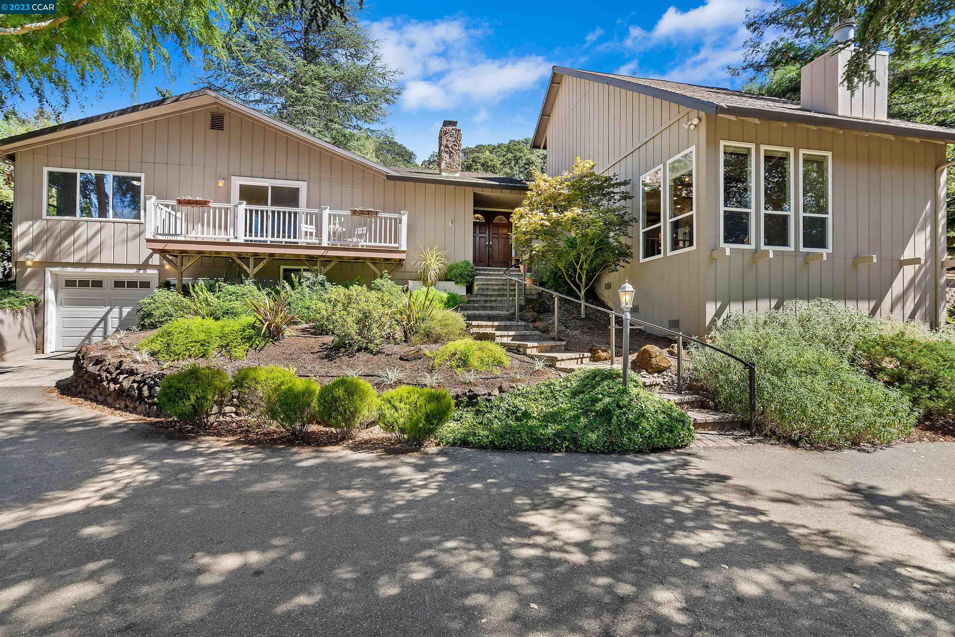 1736 Reliez Valley Road Lafayette, CA 94549 - Photo 1 of 1 a front view of a house with a yard and a garden
