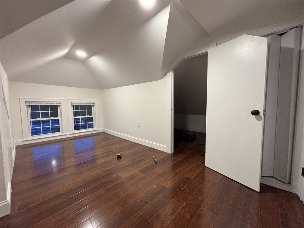 4 Appleton Street, Unit D Quincy, MA 02171 - Photo 7 of 12 an empty room with wooden floor and windows