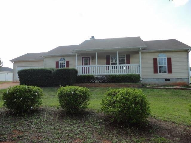 1208 South Ola Road Locust Grove, GA 30248 - Photo 1 of 1 a front view of a house with garden