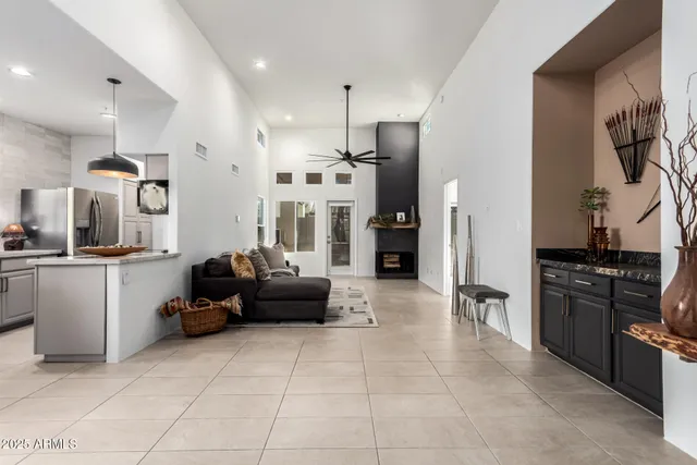 a kitchen with granite countertop a refrigerator and a stove top oven