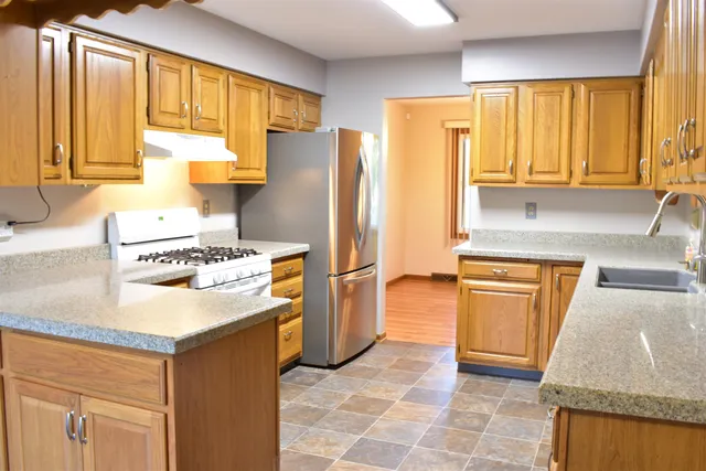 a kitchen with sink and cabinets