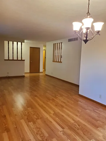 a view of an empty room with a fireplace and a window
