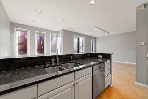 a kitchen with stainless steel appliances granite countertop a stove microwave and refrigerator