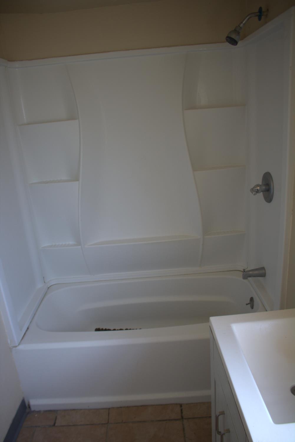 408 Thrasher Avenue Modesto, CA 95354 - Photo 13 of 13 a bathroom with a sink and bathtub