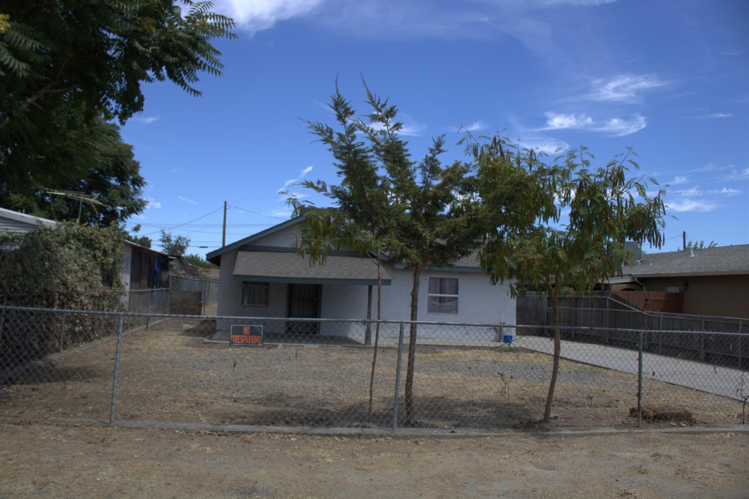 408 Thrasher Avenue Modesto, CA 95354 - Photo 2 of 13 a view of a house with a yard