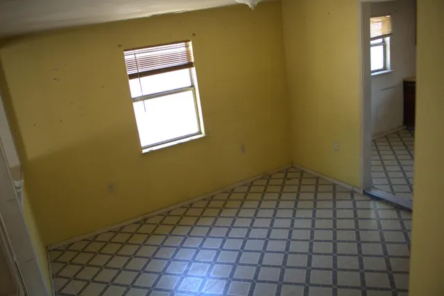 a view of an empty room and window