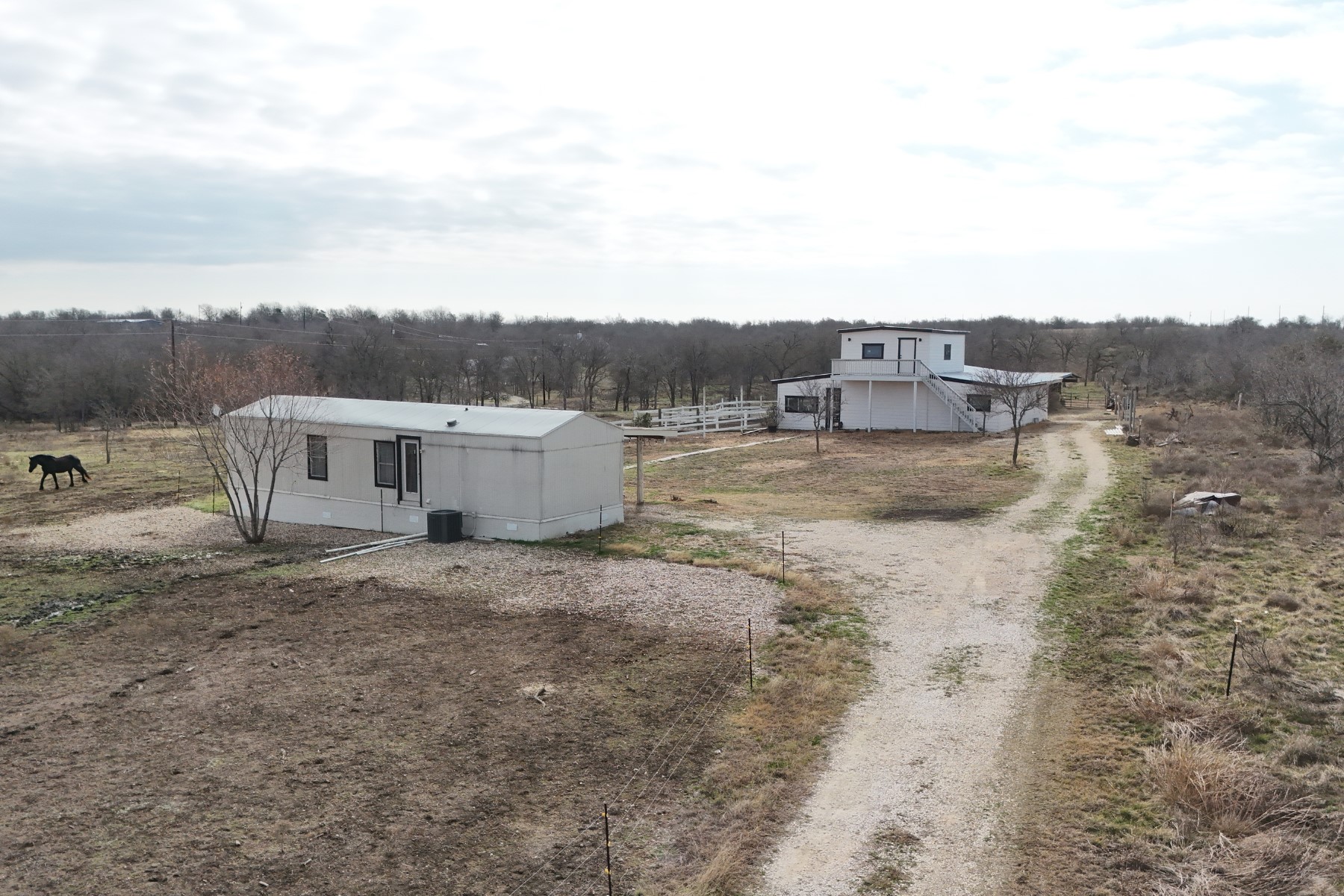 2690 County Road 466 Elgin, TX 78621 - Photo 9 of 19 a view of a dry yard with large trees