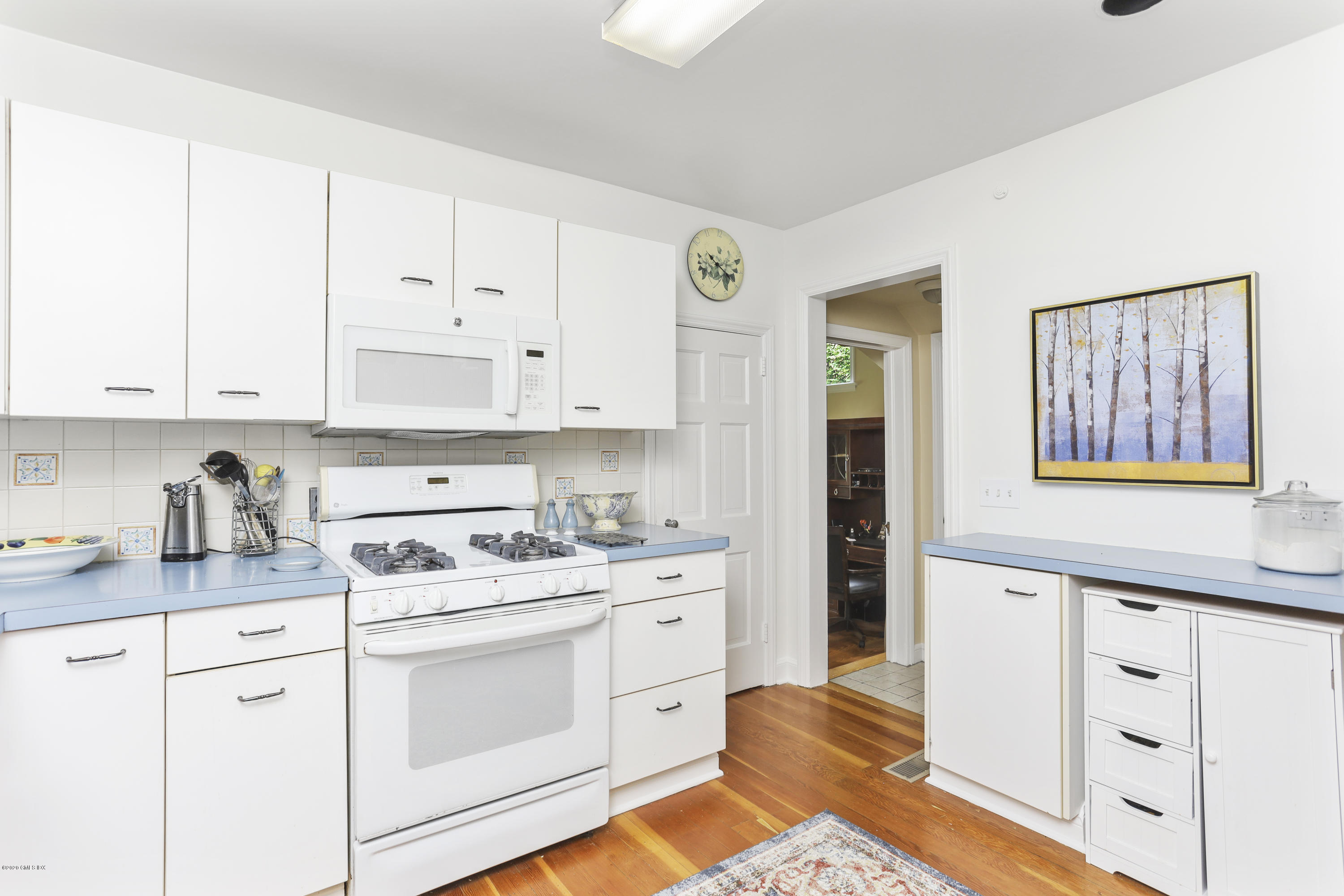 5 Terrace Avenue Riverside, CT 06878 - Photo 8 of 25 a kitchen with white cabinets appliances and sink