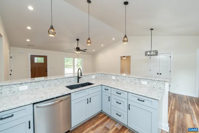 a kitchen with a sink and chandelier