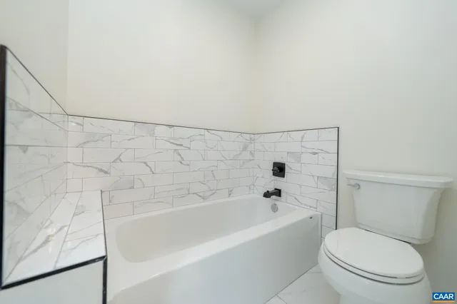 a bathroom with a toilet and a bathtub