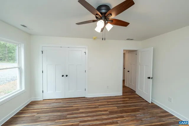 a view of a livingroom with a ceiling fan and window