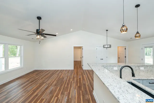 a view of a kitchen with a sink and wooden floor