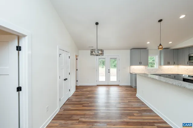 a view of a kitchen with cabinets and wooden floor