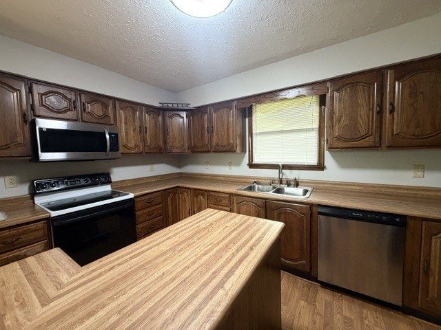 7643 Harper Road Joelton, TN 37080 - Photo 7 of 11 a kitchen with stainless steel appliances kitchen island granite countertop a sink stove and microwave