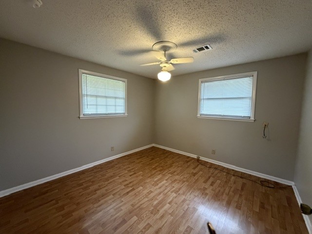 7643 Harper Road Joelton, TN 37080 - Photo 10 of 11 a view of an empty room with chandelier fan and wooden floor