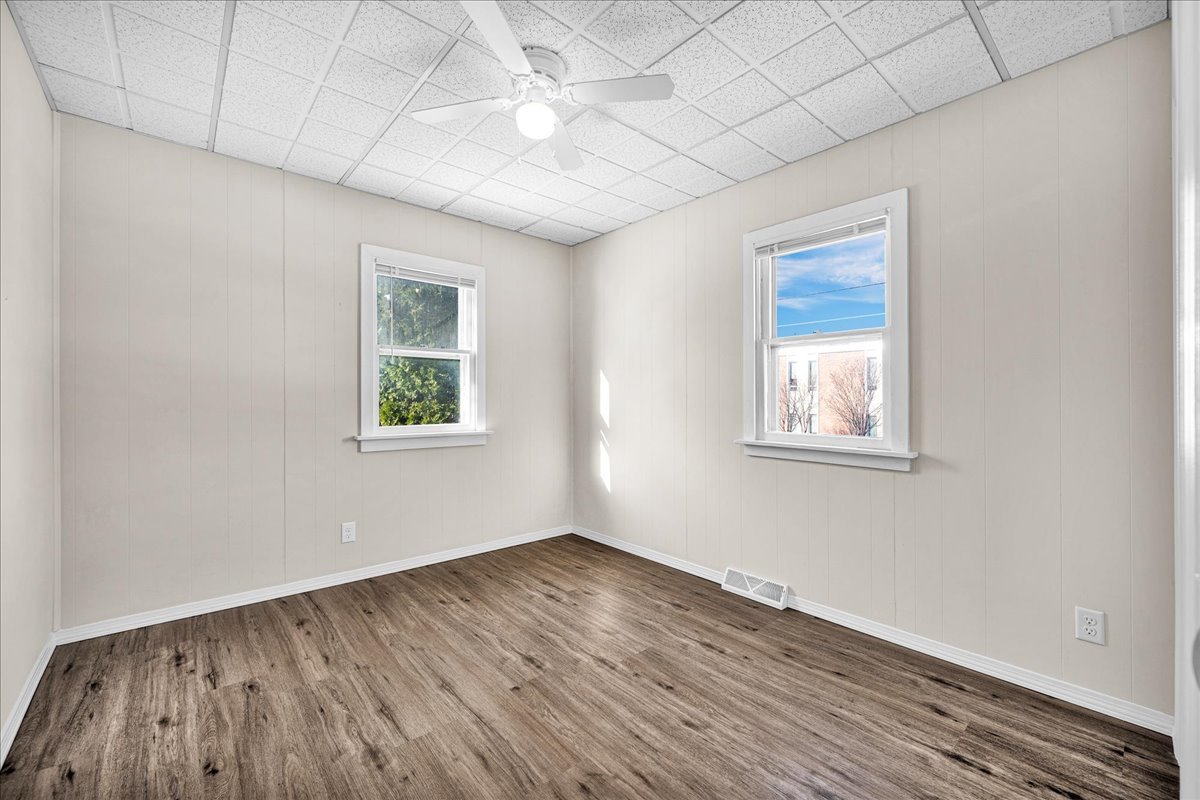 1406 West Walnut Street Bloomington, IL 61701 - Photo 14 of 32 an empty room with wooden floor and windows