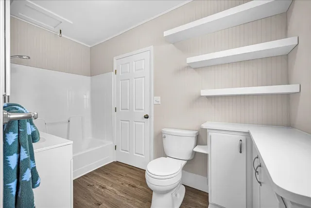 a white toilet sitting next to a bathroom sink